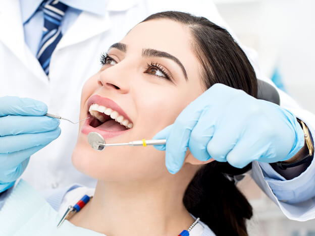 dentist-evaluating-patients-teeth